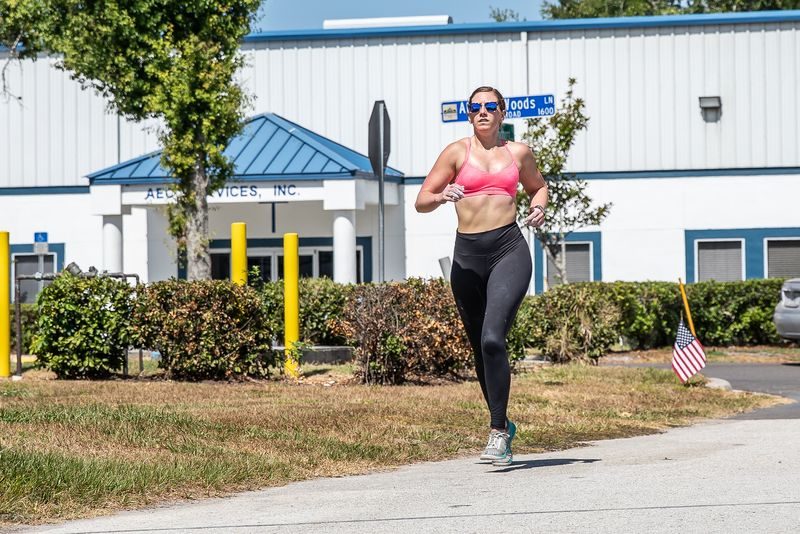 Athlete running outside the gym on Allison Woods Lane during HYROX-style race training in Tampa