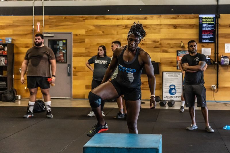 Athlete performing box step-ups during a hero workout at CrossFit Sabal Park